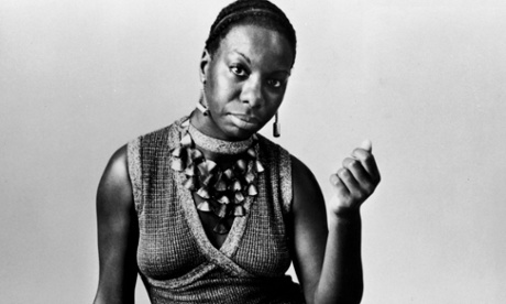 This studio portrait shows American pianist and jazz singer Nina Simone reclining on the floor circa 1968