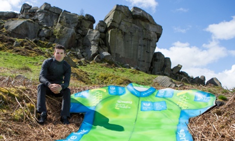Team Sky's Ben Swift and a giant replica of the Tour de Yorkshire sprinter's jersey sit beneath the Cow and Calf rocks on Ilkley Moor.