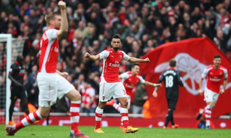 Arsenal celebrate after Alexis Sánchez, centre background, lashed home the Gunners' third goal in the win over Liverpool.