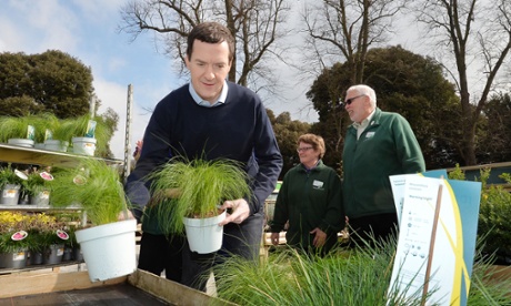 George Osborne restocks plant displays during a visit to a garden centre in west London.