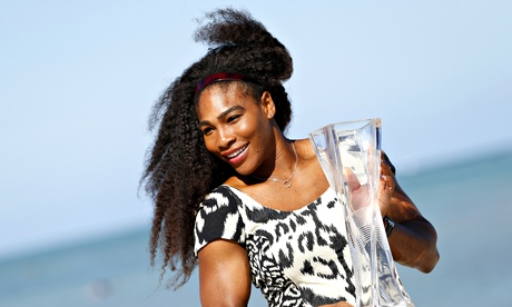 Serena Williams poses on the beach with her Miami Open trophy
