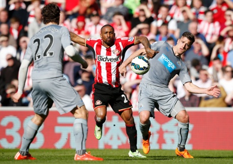 Ryan Taylor tries to hold back Jermain Defoe.