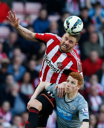 Connor Wickham meets the ball before Jack Colback.