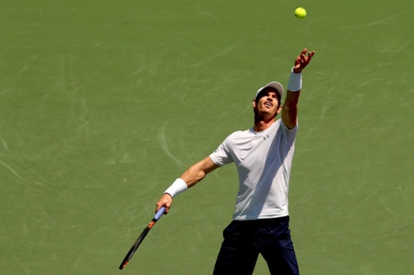 Andy Murray serves.