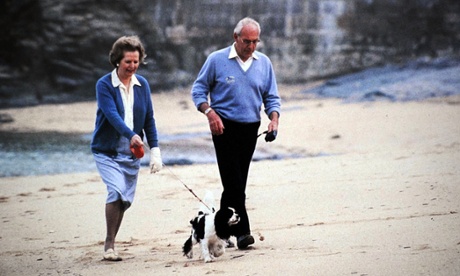 Margaret and Denis Thatcher take a dog for a walk.