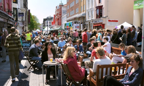 Crowds enjoy drinking outdoors at a bar in Brighton.