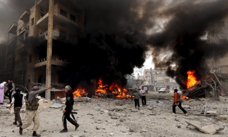 Residents and rebel fighters inspect a fire after what activists said was shelling by forces loyal to Syria's President Bashar al-Assad in Idlib.