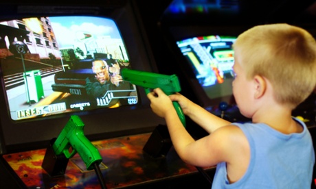 A boy aims a toy gun at an arcade game. But could access to violent games constitute neglect?