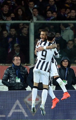 Roberto Pereyra celebrates with teammate Alvaro Morata after scoring.