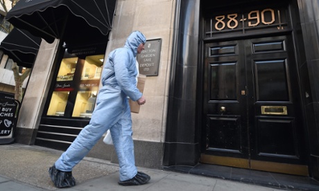 A forensics expert enters the Hatton Garden Safe Deposit Ltd store in London