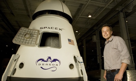 Elon Musk poses in front of the Dragon space craft. 