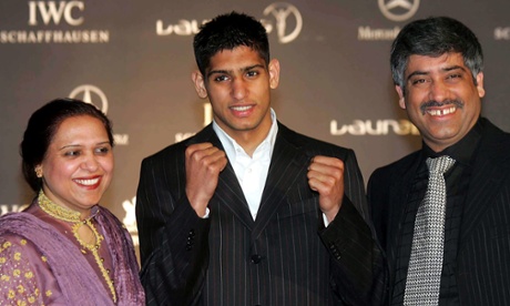Family man: Amir Khan with his proud parents. 'People are always coming up to him in restaurants and asking him to do stuff and he’s always saying yes. We have to say no for him,' says his uncle.