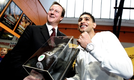 Boxing blue: presenting David Cameron with a signed glove at the opening of Amir Khan’s Gloves gym.