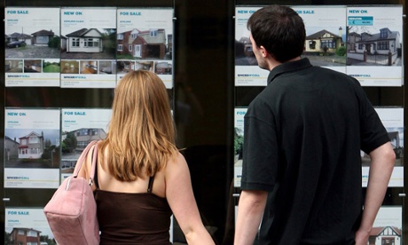 Young couple looking in an estate agent's window