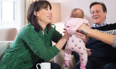 David Cameron and his wife, Samantha, pass baby Regan between them during a campaign visit to a housing development with a family in Chorley, Lancashire.