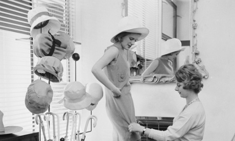 A prospective client tries on a dress at a boutique in Chelsea, 1959.