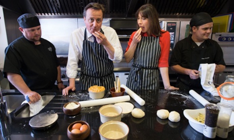 Just a regular guy: David Cameron and his wife Samantha help to make Steak, Ale and Stilton pies at Brains Brewery in Cardiff.