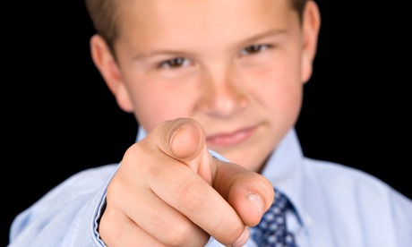 A young boy dressed up in a shirt and tie.