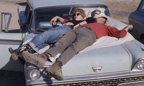 couple sleeping on car