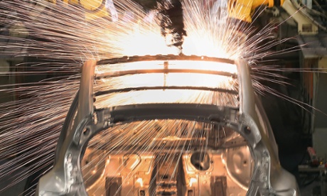 Robotic arms assemble and weld the body shell of a Nissan car on the production line at Nissan’s Sunderland plant. Though manufacturers and services were hit, new car sales hit a 15-year high in March.