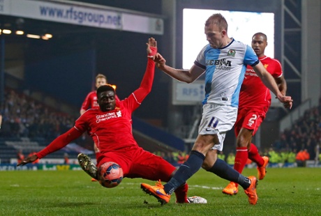 Kolo Toure manages to get a touch as Jordan Rhodes shoots.