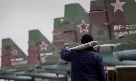 A serviceman carries an air-to-ground missile.