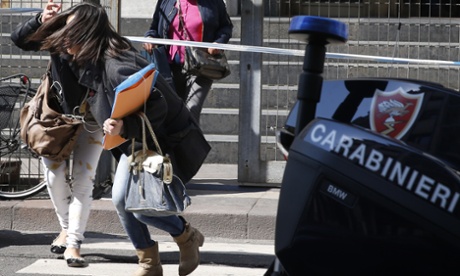 Women rush out of the court building in Milan.