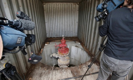 Television crews video an exploratory well-head at Horse Hill, a site near Gatwick airport in southern England.