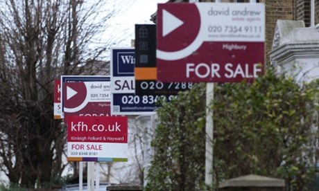 Row of for sale signs on houses.