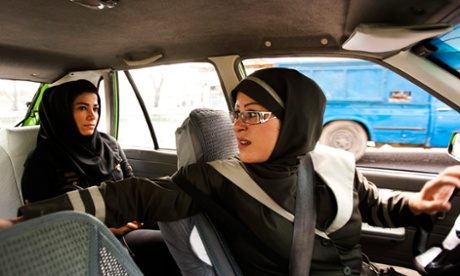 A female taxi driver fetches a passenger in Tehran, Iran.