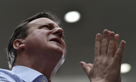 Praying with passion? David Cameron addresses workers at Asda in Leeds.