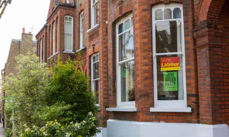 green and labour election posters in same house window