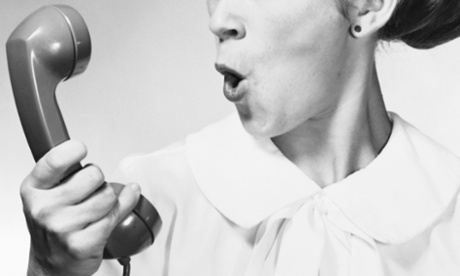 Young woman holding telephone receiver and shouting