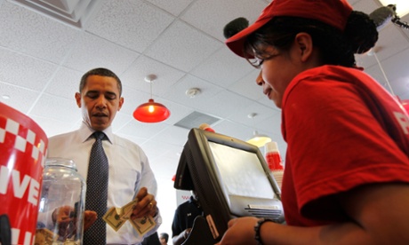 President Barack Obama orders a hamburger at Five Guys in Washington.