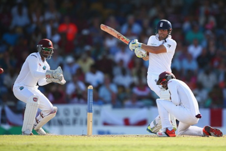 Alastair Cook pulls to the leg side as Jermaine Blackwood takes cover.