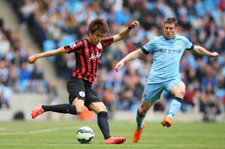 Suk-Young Yun crosses one in ahead of James Milner.