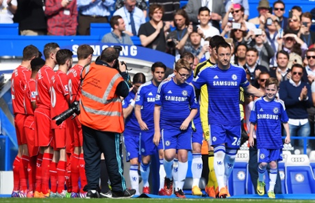 John Terry of Chelsea leads out his team through a guard of honour by the Liverpool players.