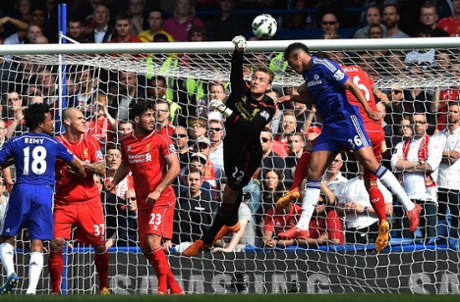 Simon Mignolet punches clear.