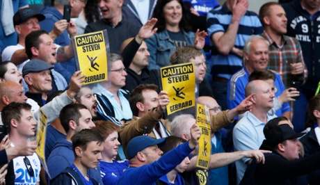 Chelsea's fans hold signs.