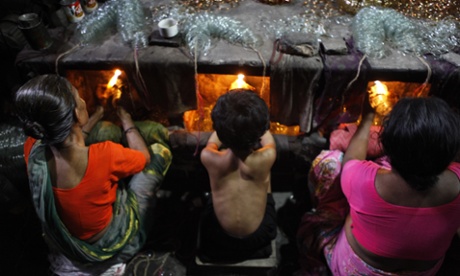 A child works in front of small kiln at a glass bangle factory in Dhaka, Bangladesh.