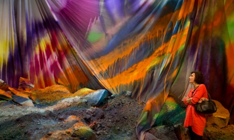 A visitor views an artwork by German artist Katharina Grosse.