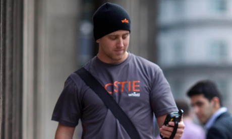 A Whistl postman makes a delivery in the City of London.