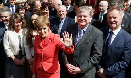 Nicola Sturgeon, waves as she poses with newly-elected SNP MPs.