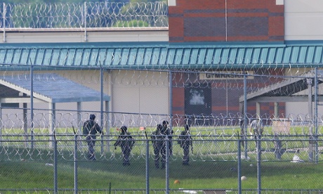 Armed personnel patrol the grounds of the Tecumseh state correctional institution, in Tecumseh, Nebraska on Monday following a prison riot.