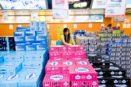An employee restocks supplies of alcohol for sale aboard the AS Tallink Grupp ferry Baltic Queen.