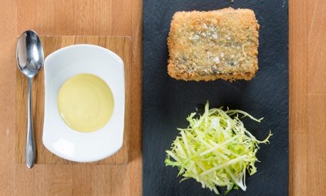 Wild Garlic's crispy pork belly with black pudding on a slate tile