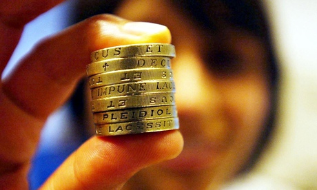 A person holding up some coins