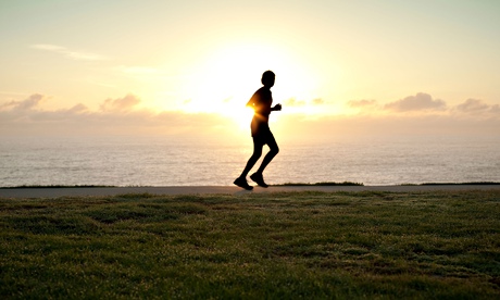 A silhouette of a jogger running alone with sun on horizon. Image shot 2010. Exact date unknown.