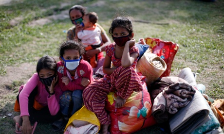 Nepalese girls stay with their belongings on an open ground after another earthquake in Kathmandu.