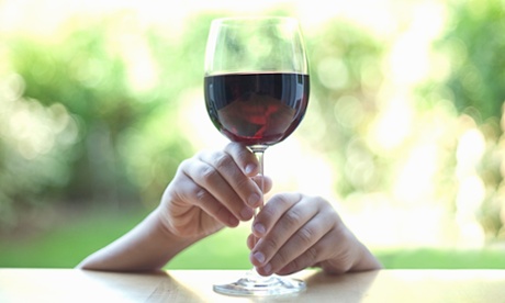 Hands holding stem of wine glass